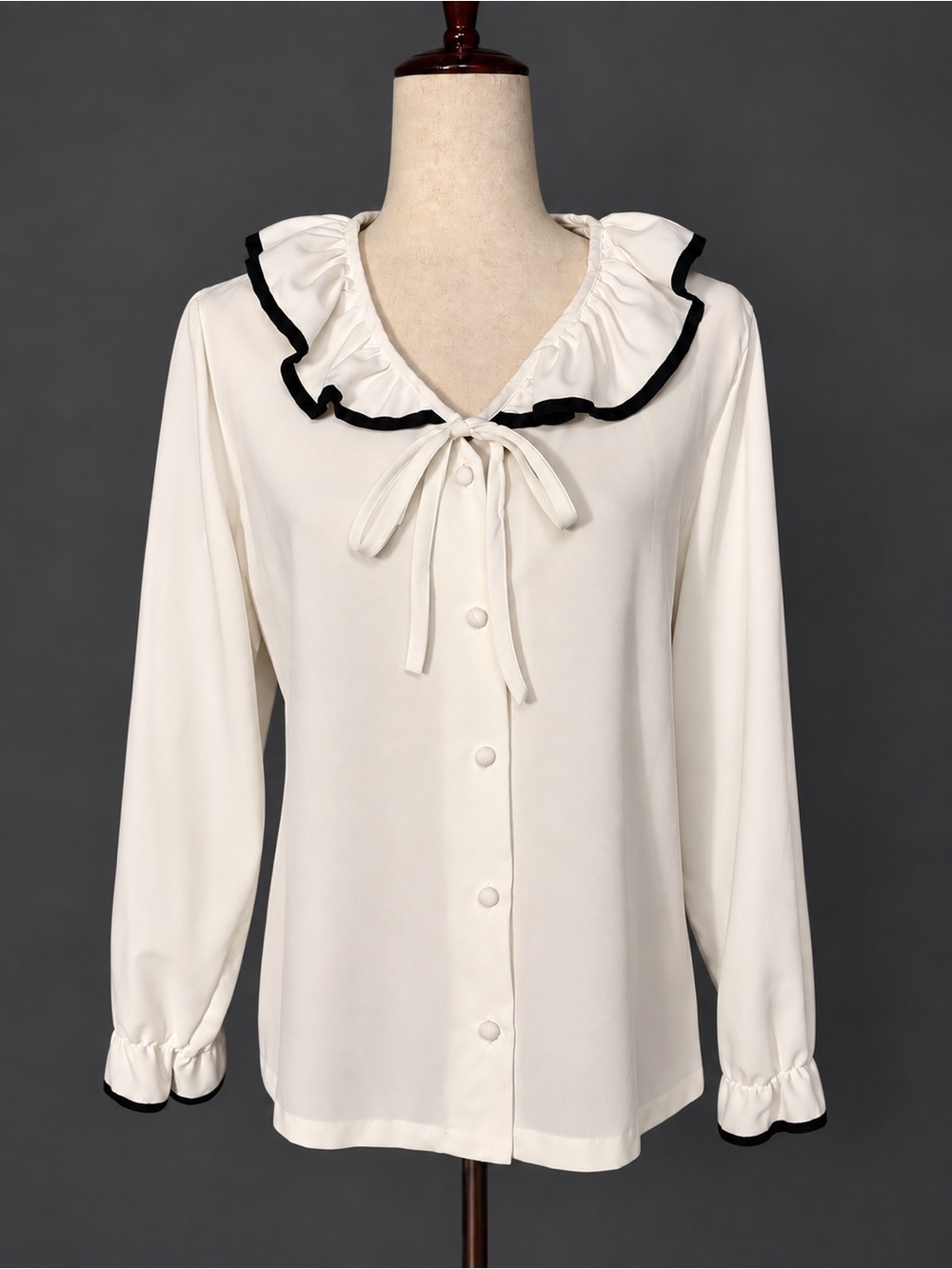 Vintage early 80s white polyester ruffle neck top with bow and black trim. M